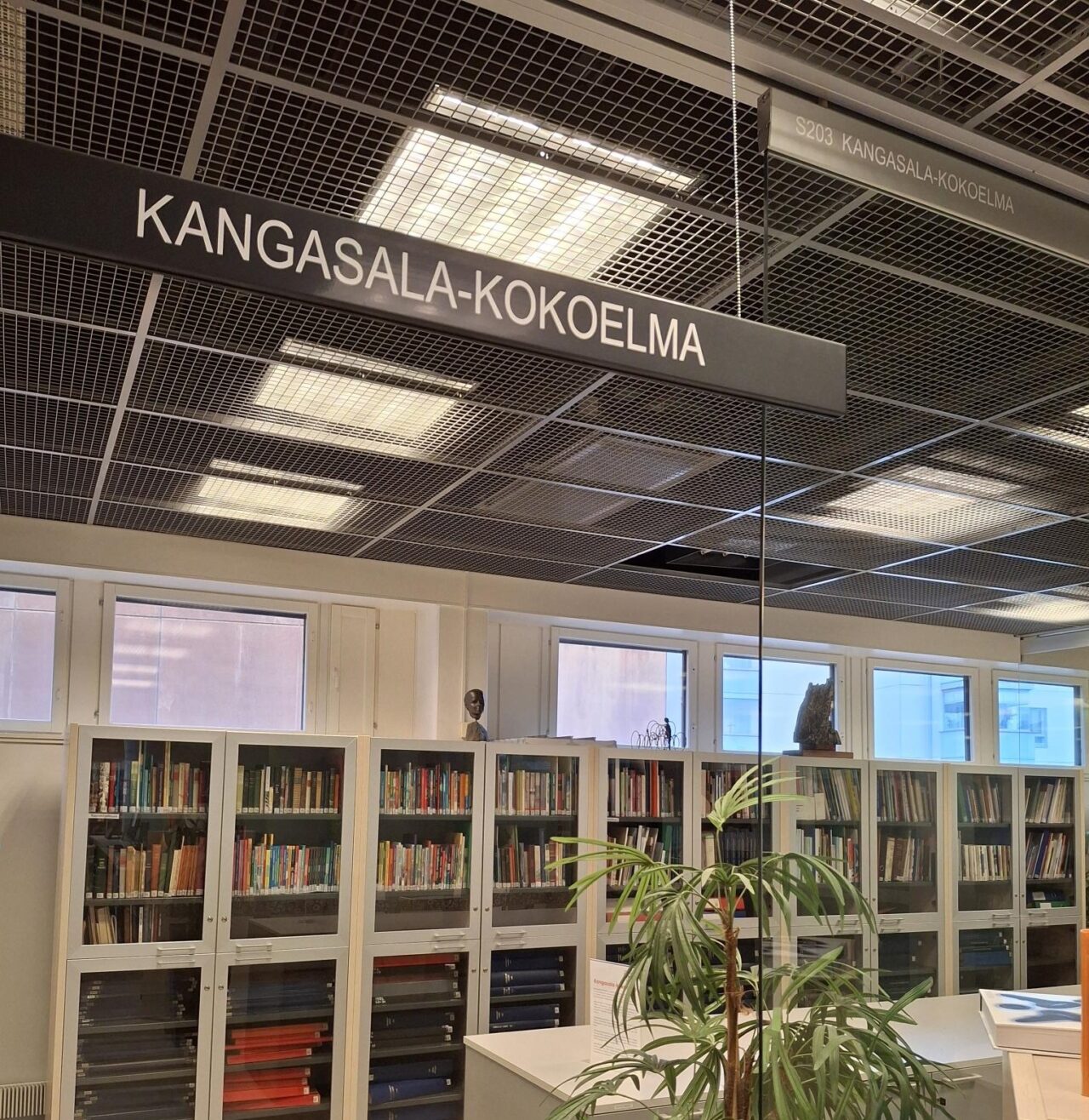 Paljon kirjahyllyjä sisältävä Kangasala-kokoelman tila.