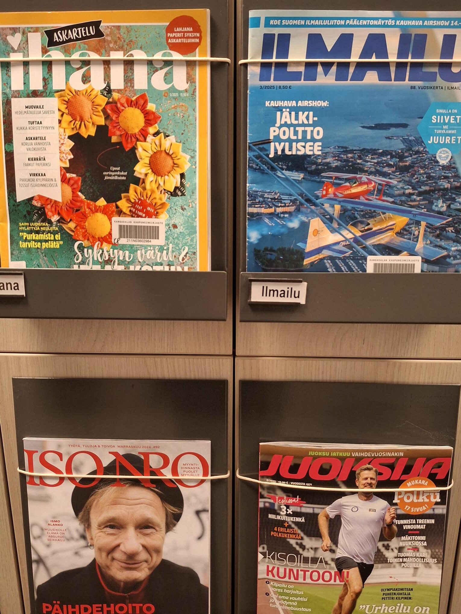 Hylly, jonka ovissa aikakauslehtiä kansi eteenpäin esillä.